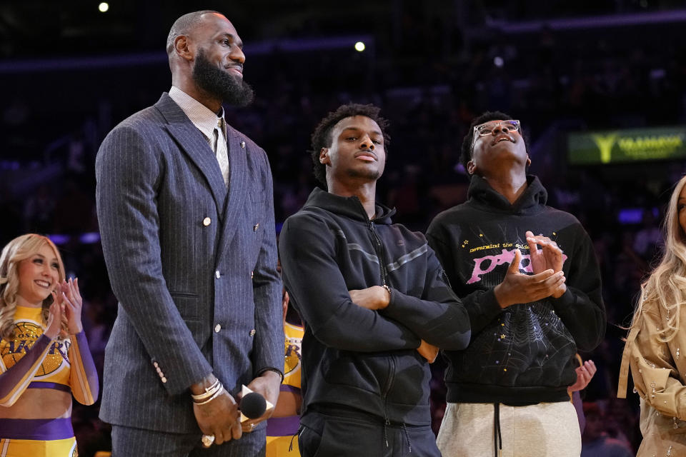 FILE - Los Angeles Lakers forward LeBron James, second from left, Bronny James, center, and Bryce James stand during a ceremony honoring LeBron James as the NBA&#39;s all-time leading scorer, before the Lakers&#39; basketball game against the Milwaukee Bucks on Feb. 9, 2023, in Los Angeles. Bronny James was hospitalized in stable condition Tuesday, July 25, 2023, a day after going into cardiac arrest while participating in a practice at the University of Southern California, a family spokesman said. (AP Photo/Mark J. Terrill)