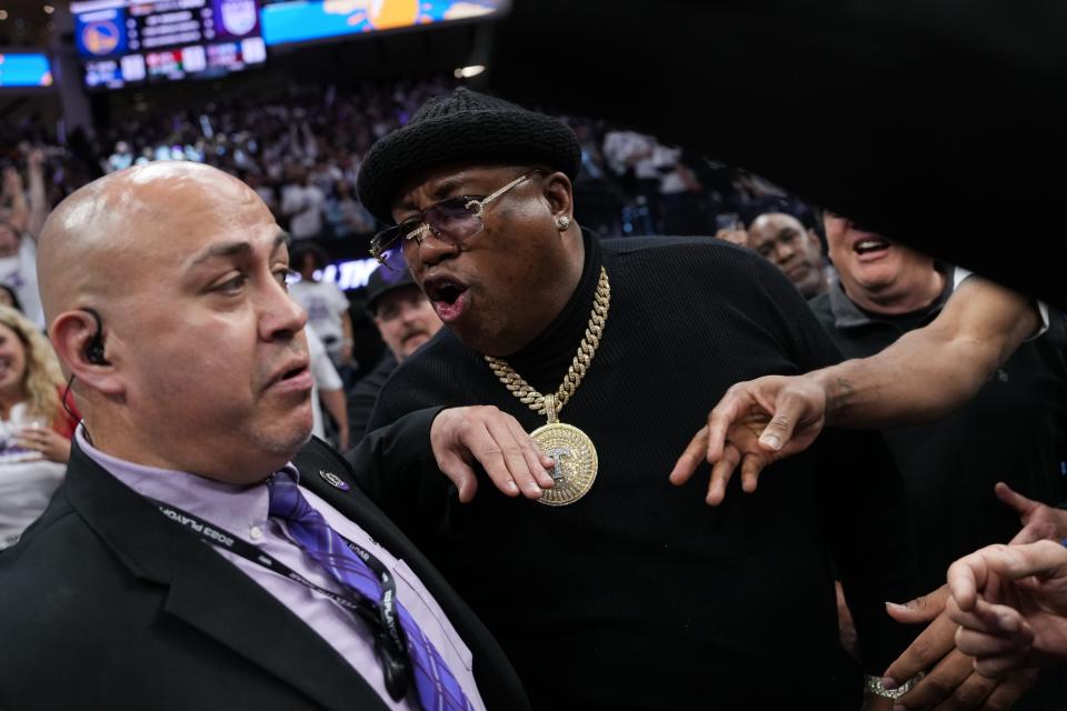Rapper E-40 yells at arena security personnel before being escorted from courtside seating during Game 1 of Saturday's Western Conference playoff game between the Warriors and Kings in Sacramento.