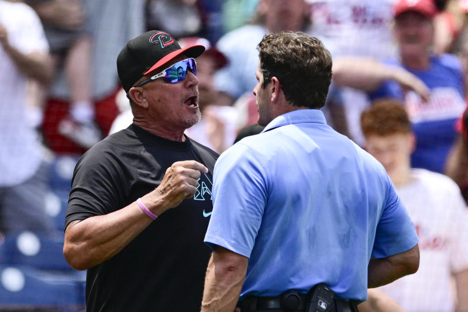 Arizona Diamondbacks bench coach Jeff Banister, left, argues after he was ejected by umpire Ben May, right, during the sixth inning of a baseball game against the Philadelphia Phillies, Sunday, June 23, 2024, in Philadelphia. (AP Photo/Derik Hamilton)