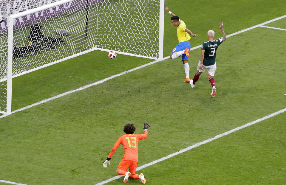 Game over: Roberto Firmino twists to tap home Neymar’s cross in the closing stages. (AP Photo/Sergei Grits)