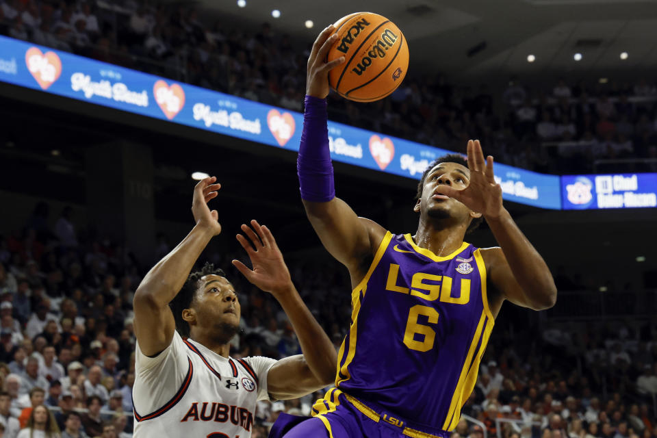 LSU guard Jordan Wright (6) goes for a layup as Auburn guard Chaney Johnson defends during the first half of an NCAA college basketball game Saturday, Jan. 13, 2024, in Auburn, Ala. (AP Photo/Butch Dill)