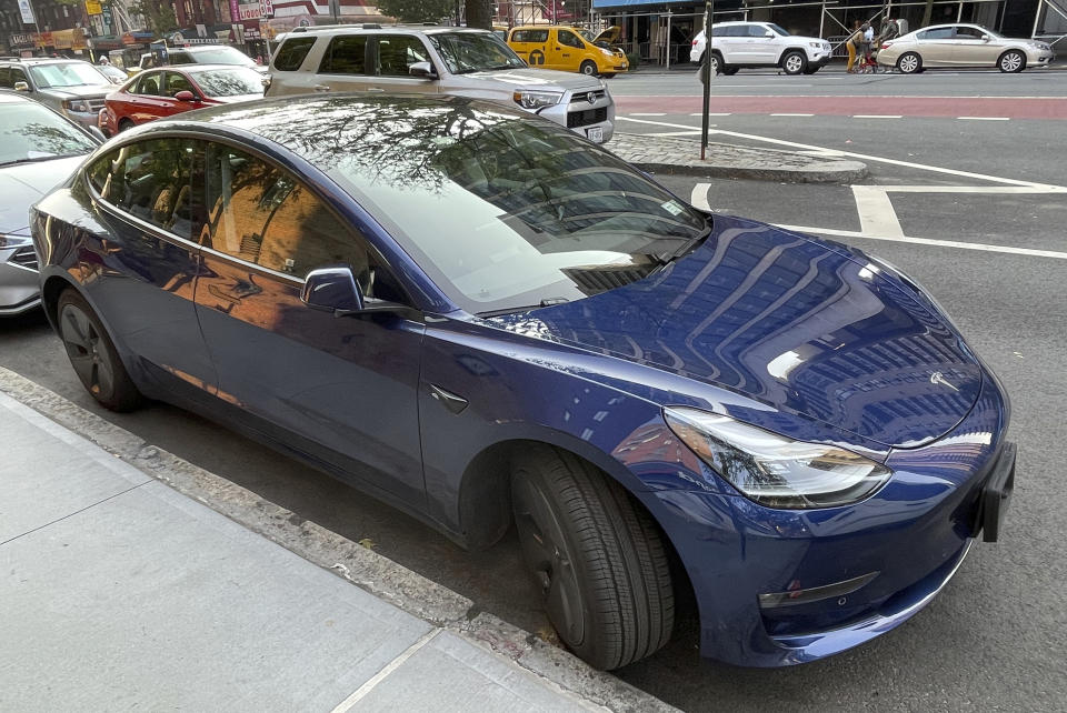 Photo by: STRF/STAR MAX/IPx 2021 7/26/21 Tesla profit surge driven by record car deliveries. STAR MAX Photo: 7/26/21 A Blue Tesla is seen in Manhattan.