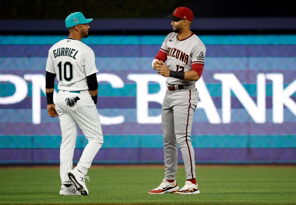 Miami Marlins first baseman Yuli Gurriel (10) and brother Arizona Diamondbacks left fielder Lourdes Gurriel Jr. (12) meet in the outfield before an game in April at loanDepot Park.
