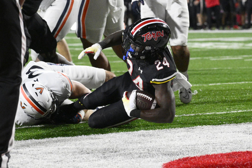 Maryland running back Roman Hemby (24) scores a touchdown past Virginia linebacker Josh Ahern, left, during the second half of an NCAA college football game Friday, Sept. 15, 2023, in College Park, Md. (AP Photo/Nick Wass)