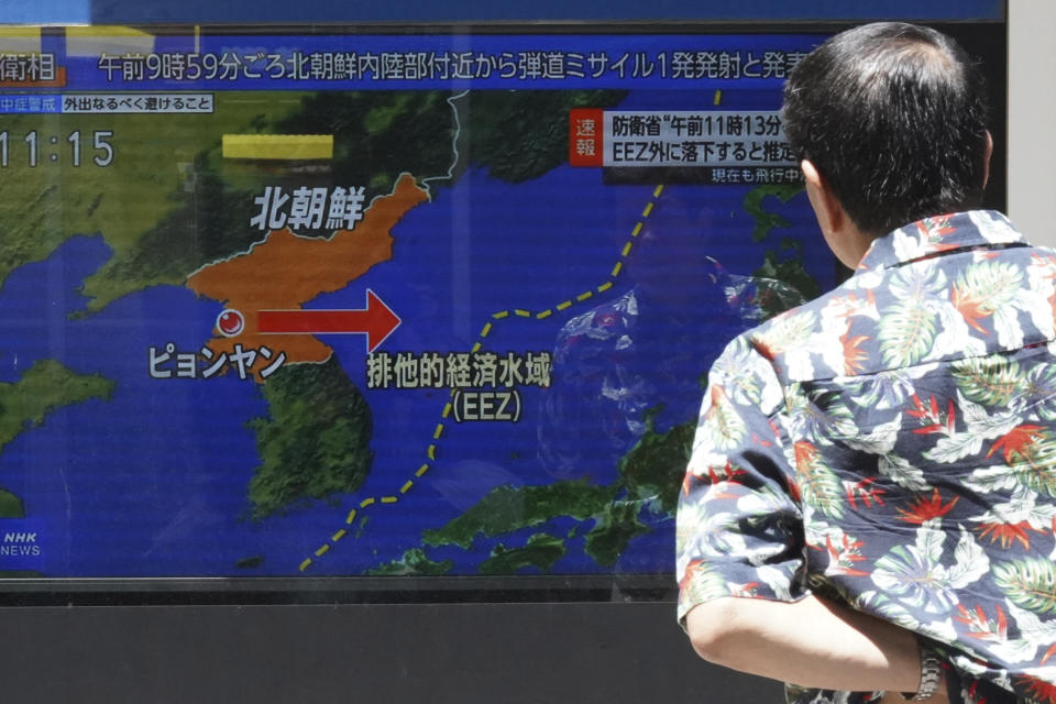 A man stands along a sidewalk to watch a TV showing a news program on North Korea's missile launch Wednesday, July 12, 2023, in Tokyo. North Korea launched a long-range ballistic missile toward its eastern waters Wednesday, its neighbors said, two days after the North threatened “shocking” consequences to protest what it called a provocative U.S. reconnaissance activity near its territory.(AP Photo/Eugene Hoshiko)