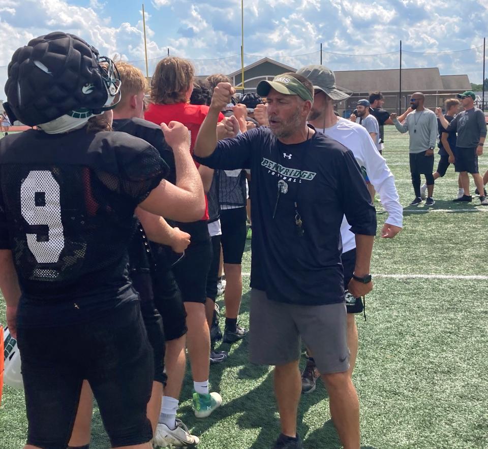 New Pennridge football coach Kyle Beller greets his players after practice.