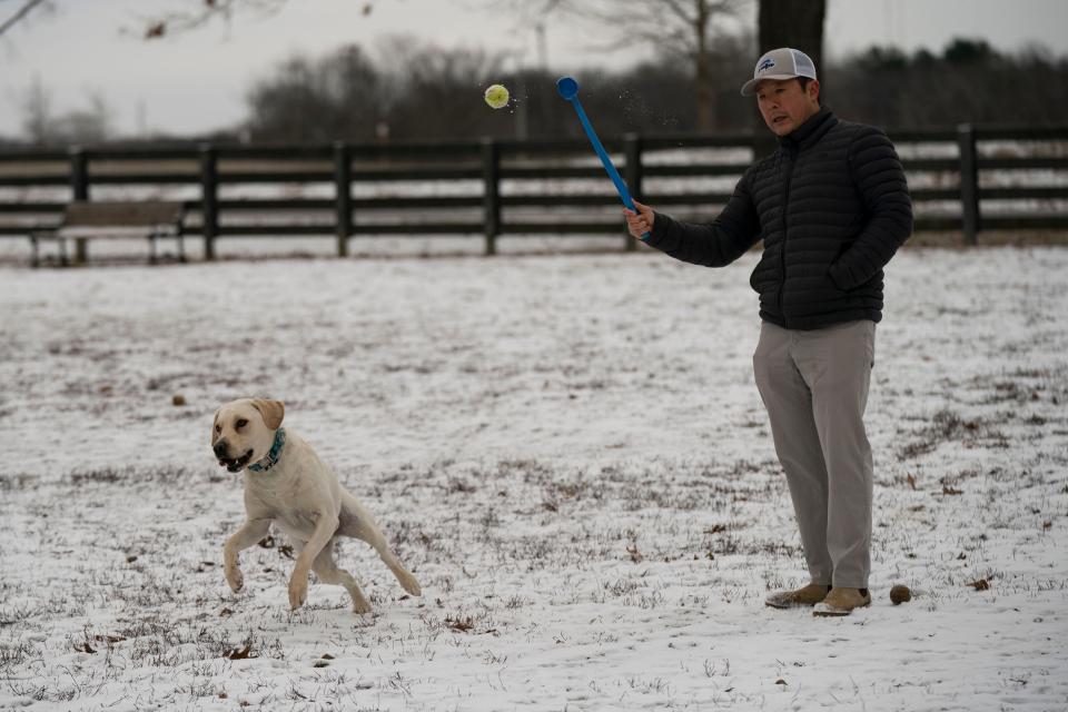 Jon Stanley enjoys playing with his dog Beau at the dog park in Edwin Warner Park Monday, Dec. 26, 2022 in Nashville, Tenn. Light snow showers blanketed the area with accumulations of about 1 inch.