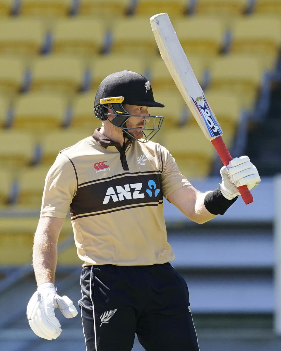 New Zealand's Martin Guptill celebrates 50 runs against Australia during their 5th T20 cricket international match at Wellington Regional Stadium in Wellington, New Zealand, Sunday, March 7 , 2021. (John Cowpland/Photosport via AP)