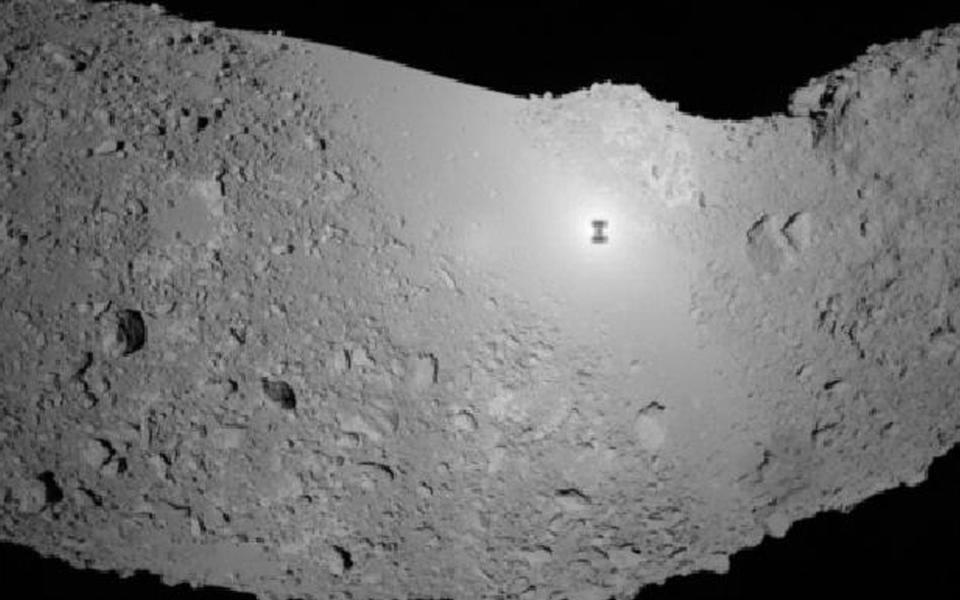  In this photo released by the Japan Aerospace Exploration Agency (JAXA), the part of asteroid Itokawa is seen with the shadow of probe Hayabusa, center - AP Photo/Japan Aerospace Exploration Agency