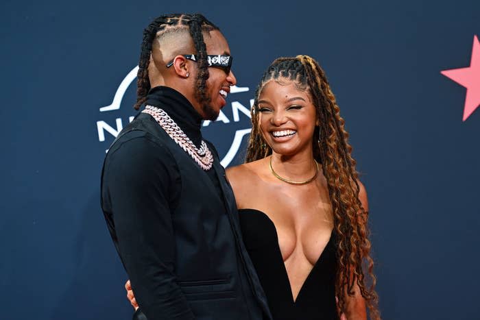 DDG and Halle smiling widely at a red carpet event