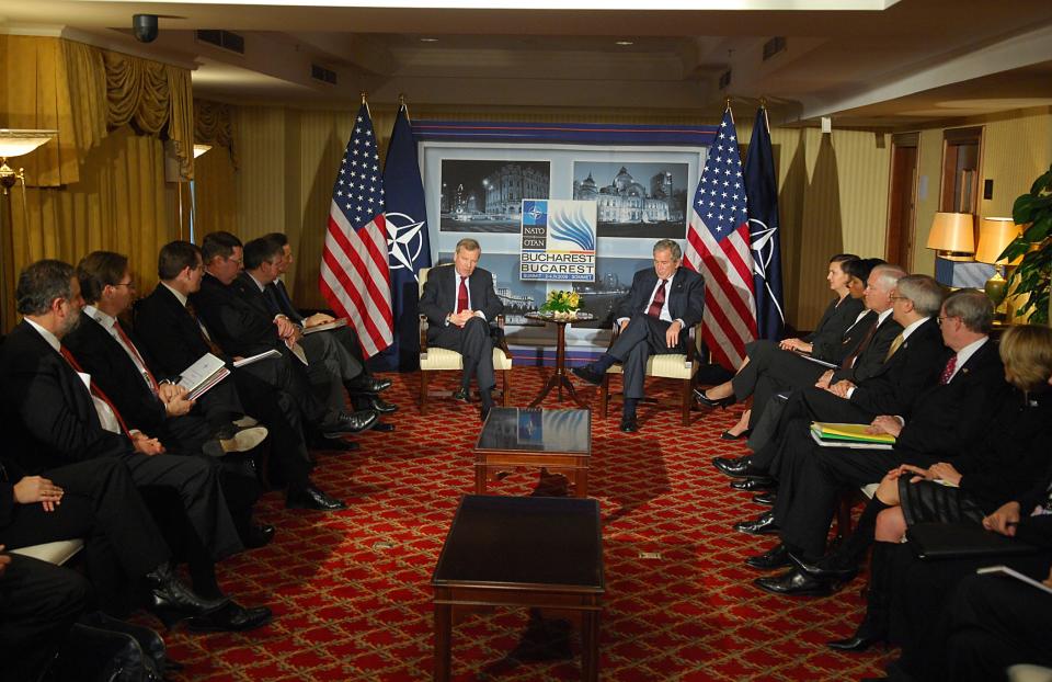 NATO leaders, including then-President George W. Bush, sit during a meeting at the Bucharest Summit. 