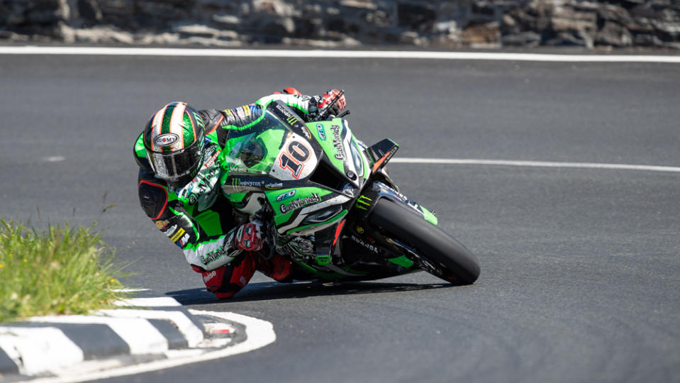 Racer Peter Hickman rides his BMW M 1000 RR on the way to victory at the 2022 Isle of Man TT.