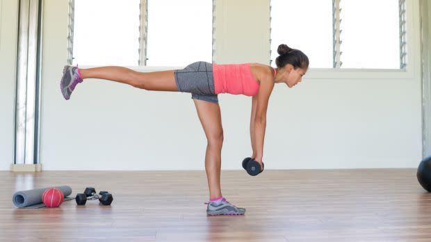 Woman performs single-leg Romanian deadlift with a dumbbell