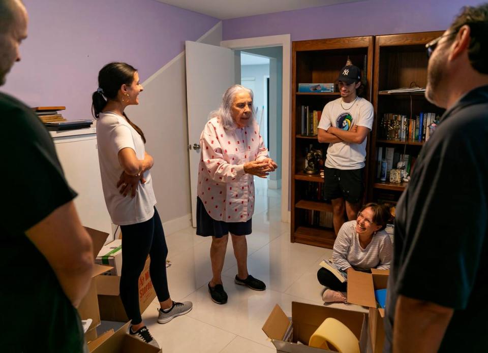 Ana Lazara Rodriguez, center, tells a story as friends help her move into her new home in Miami’s Coral Terrace neighborhood on Monday, Sept. 27, 2021. Rodriguez, who was previously facing eviction, was able to move into this house after an anonymous benefactor bought her the four-bedroom, two-bath home for $690,000.