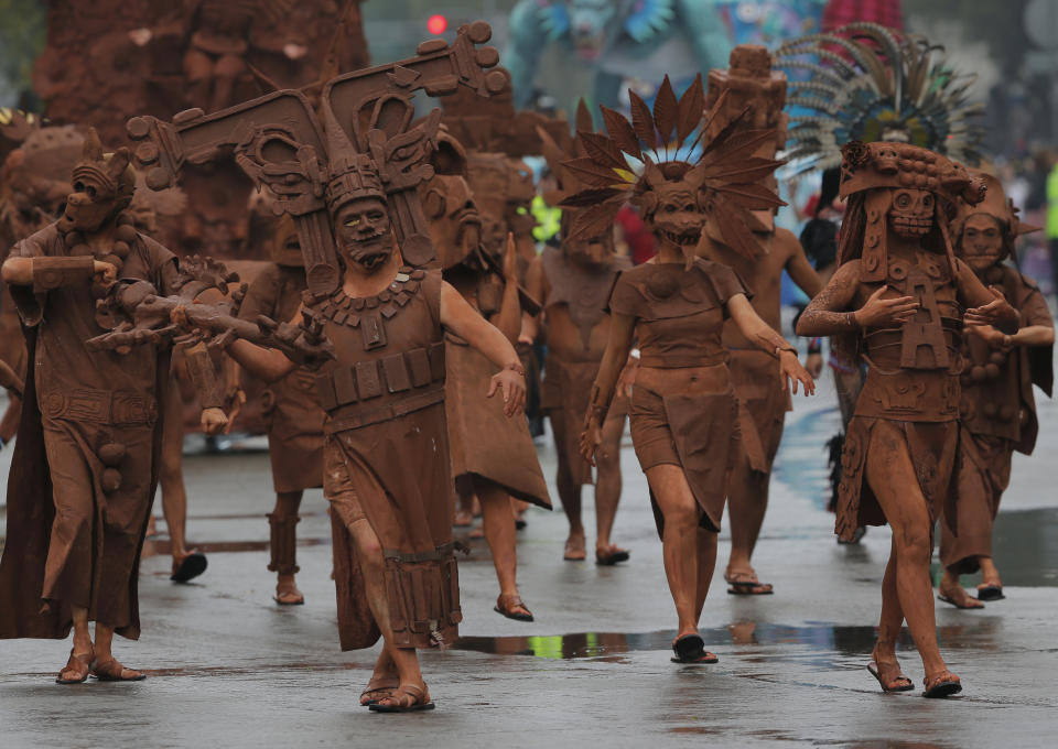 Performers dressed as pre-columbian deities participate in the Day of the Dead parade in Mexico City, Saturday, Nov. 2, 2019. (AP Photo/Ginnette Riquelme)