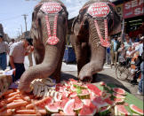 <p>Elephants from the Ringling Bros. and Barnum & Bailey Circus eat their lunch in Philadelphia’s Italian market, May 28, 1997. (AP Photo/Dan Loh) </p>
