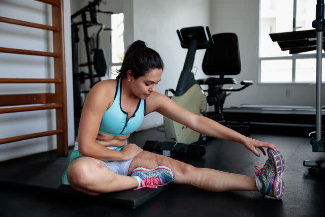 <p>PatrÃ­cia Monteiro / Getty Images</p> Female stretching after exercise