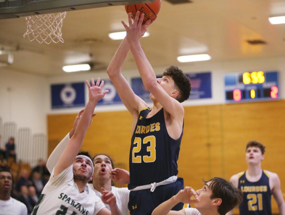 Lourdes' Zach Hart goes for a layup against Spackenkill's Sanad Sahawneh during the MHAL boys basketball final on February 23, 2023. 