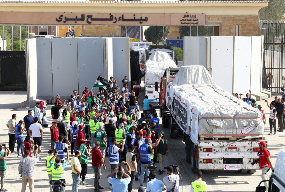 Crowds gather as the first aid trucks crossed the Rafah border into Gaza from Egypt on Saturday (Reuters)