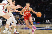 Ohio State guard Jacy Sheldon (4) drives towards the basket as UConn guard Nika Muhl, left, closes in on defense in the first quarter of a Sweet 16 college basketball game of the NCAA Tournament in Seattle, Saturday, March 25, 2023. (AP Photo/Caean Couto)