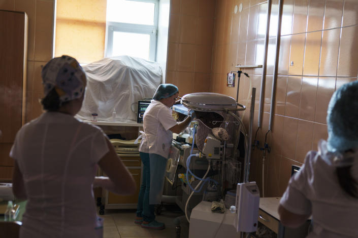 Misha, a baby born prematurely at 33 weeks, is checked on by staff in a room fortified with sandbags in the window at the Pokrovsk Perinatal Hospital, the only one under government control remaining equipped to care for premature babies, in Pokrovsk, Donetsk region, eastern Ukraine, Monday, Aug. 15, 2022. Before Russia's invasion of Ukraine in late February, three hospitals had the facilities to care for premature babies in government-controlled areas of Donetsk, the war-torn region in the east of the country. (AP Photo/David Goldman)