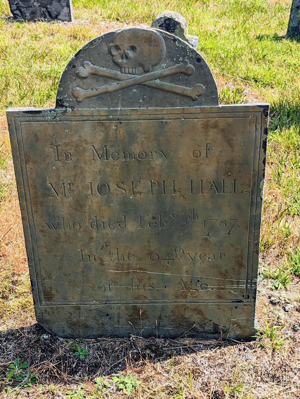 Some of the headstones with wingless skull and crossbones signify mortality and are an example of the style of John Homer of Boston.