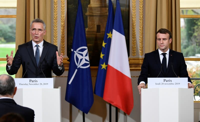 French President Emmanuel Macron and NATO Secretary General Jens Stoltenberg give a news conference after their meeting at the Elysee palace in Paris