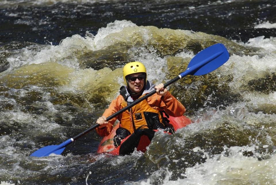 In this Aug. 24, 2013 photo provided by James Swedberg, Phil Brown maneuvers a ducky through the waves of the Blue Ledge Narrows in the Hudson River Gorge in Minerva, N.Y. The solo raft nearly unsinkable, doesn't require the skill of a true whitewater kayaker or canoeist. But it's the same intimate, wild view. (AP Photo/James Swedberg, James Swedberg)