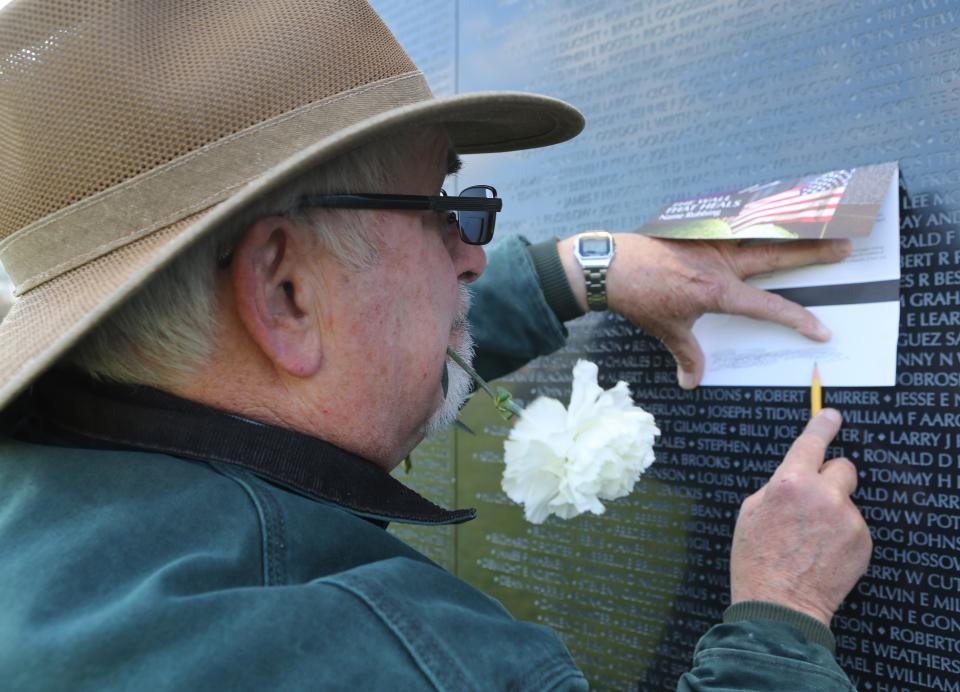 Tom Lauppe, of Middletown, takes a rubbing of William H. Thigpen's name from The Wall That Heals Thursday morning near New Castle.  Thomas and William were friends and classmates while they were growing up in North Carolina.