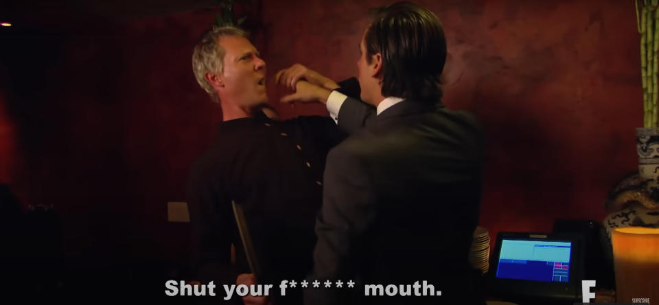 Scott Disick shoving money in a waiter's mouth