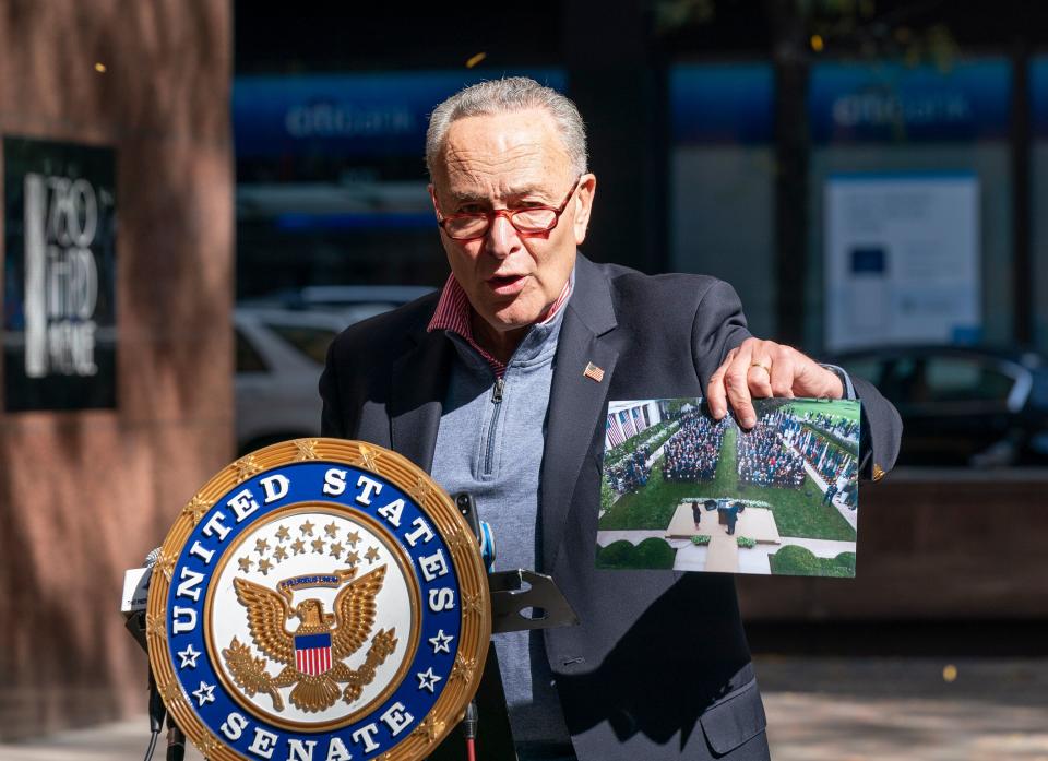 Senate Minority Leader Chuck Senator, speaking in New York City on Oct. 4, holds up a picture of the Rose Garden ceremony where the coronavirus likely spread. (Lev Radin/Pacific Press/LightRocket via Getty Images)