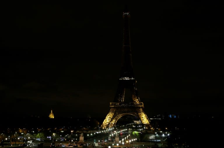 The lights of the Eiffel Tower in Paris are switched off in tribute to the victims of the deadly attack on a mosque in Egypt's Sinai