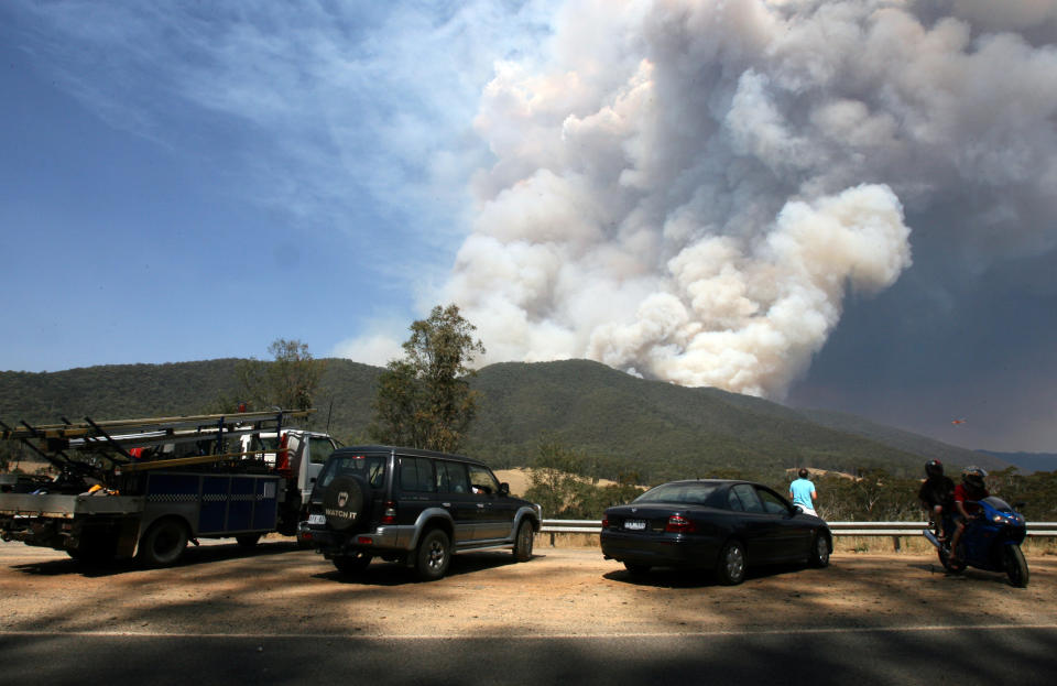 Fire burning from mountain near Bright, which turned the Victorian Alpine Region into a ghost town.