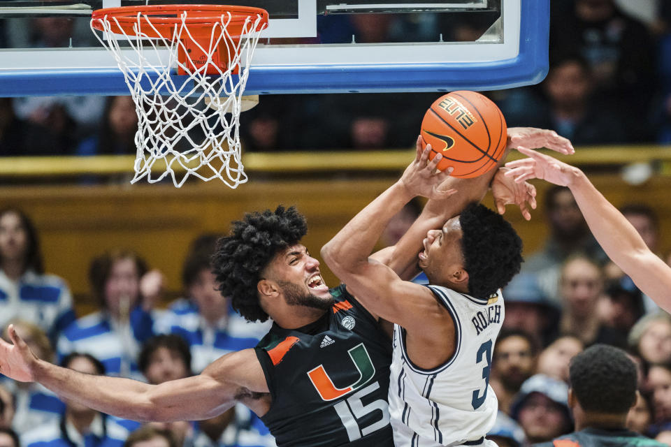 Miami forward Norchad Omier (15) fouls Duke guard Jeremy Roach (3) in the first half of an NCAA college basketball game on Saturday, Jan. 21, 2023, in Durham, N.C. (AP Photo/Jacob Kupferman)