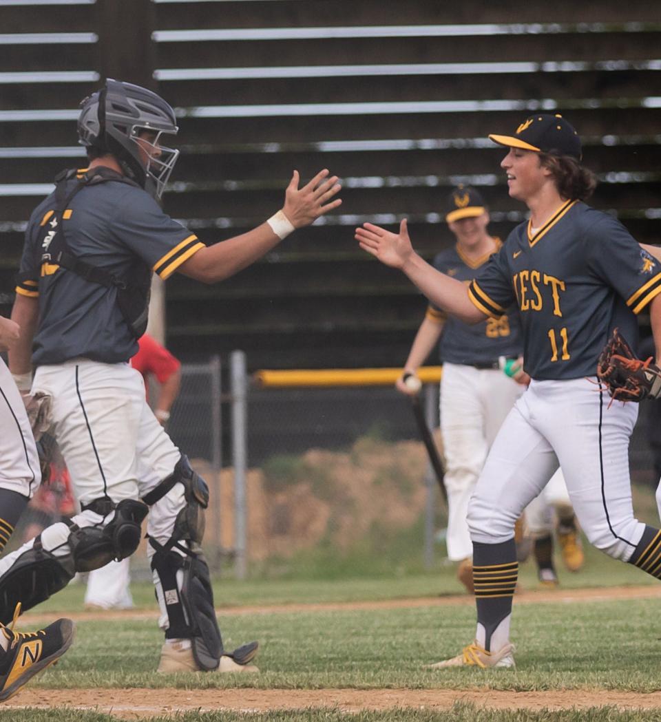 Central Bucks West catcher Max McGlone and pitcher Julio Ermigiotti celebrate a 2-1 District One playoff win over Neshaminy in 2022.