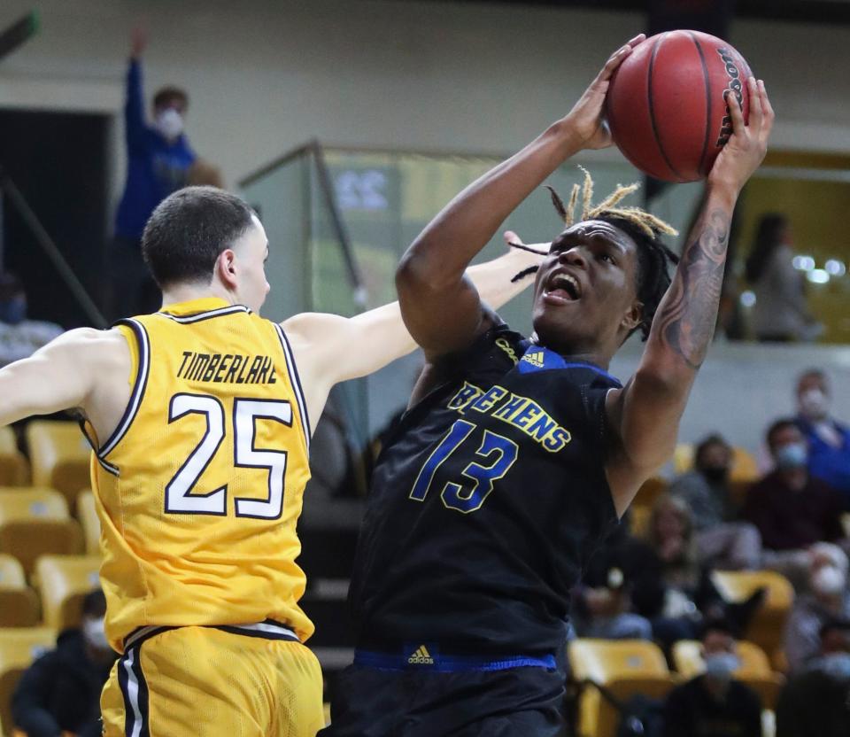 Delaware's Jyare Davis goes to the basket against Towson's Nicolas Timberlake in the first half of the Blue Hens' visit to Towson, Thursday, Jan. 27, 2022.