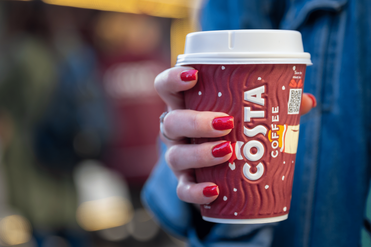 Closeup of Hand Holding Cup of Costa Coffee, Cardiff, Wales