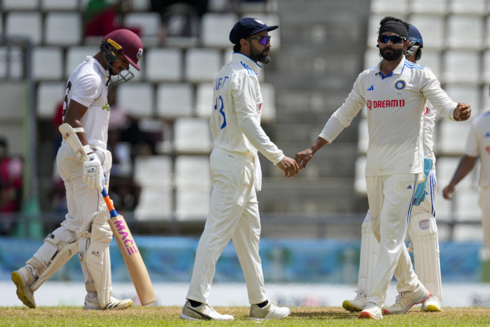 India's Ravindra Jadeja, right, celebrates with teammate Virat Kohli the dismissal LBW of West Indies' Tagenarine Chanderpaul on day three of their first cricket Test match at Windsor Park in Roseau, Dominica, Friday, July 14, 2023. (AP Photo/Ricardo Mazalan)