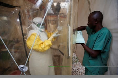 A health worker wearing Ebola protection gear enters the Biosecure Emergency Care Unit at the ALIMA Ebola treatment centre in Beni