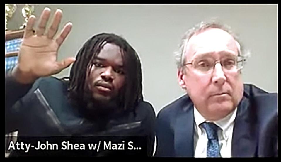 In this screen capture from YouTube, University of Michigan football player Mazi Smith, 21, is sworn in as he appeared before Judge J. Cedric Simpson from his attorney John Shea's office Thursday, December 8, 2022. He was charged with carrying a concealed weapon, a felony, nearly two months after the traffic stop.