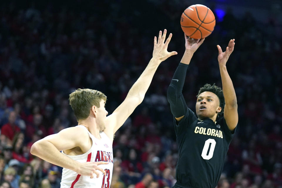 Colorado guard Shane Gatling (0) shoots over Arizona forward Stone Gettings during the first half of an NCAA college basketball game Saturday, Jan. 18, 2020, in Tucson, Ariz. (AP Photo/Rick Scuteri)