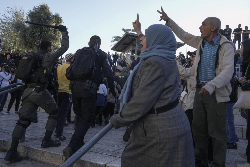 Palestinians chant slogans as Israeli security forces escort a group of Jews outside Damascus Gate, in Jerusalem's Old City, Wednesday, April 20, 2022. Police prevented hundreds of ultra-nationalist Israelis from marching around predominantly Palestinian areas of Jerusalem's Old City. The event planned for Wednesday was similar to one that served as one of the triggers of last year's Israel-Gaza war. AP Photo/Mahmoud Illean)