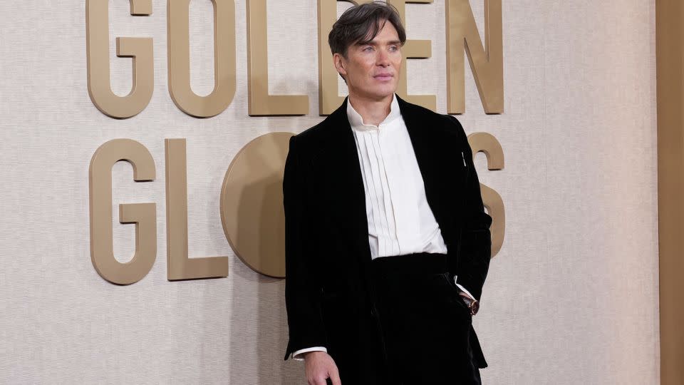 Cillian Murphy, who went on to win a Golden Globe for his performance in “Oppenheimer,” wore a classic black Saint Laurent suit with a white shirt and no tie. - Jordan Strauss/Invision/AP