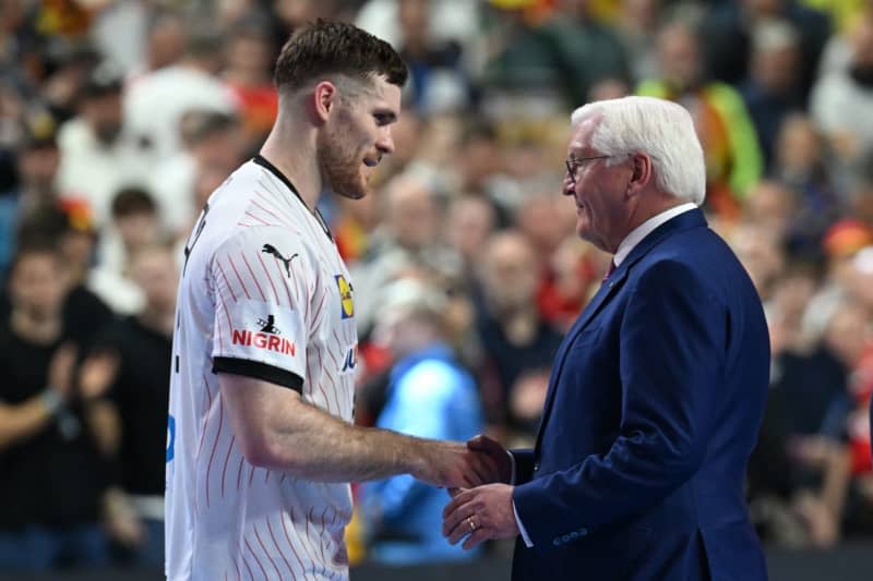 Germany's Johannes Golla and German President Frank-Walter Steinmeier talk after the 2024 EHF European Men's 3rd place Handball match between Sweden and Germany at Lanxess Arena. Federico Gambarini/dpa