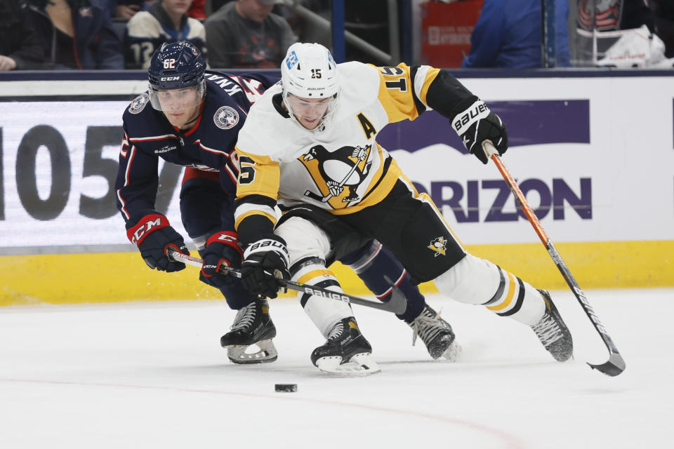 Columbus Blue Jackets' Samuel Knazko, left, and Pittsburgh Penguins' Josh Archibald fight for a loose puck during the third period of a preseason NHL hockey game Sunday, Sept. 25, 2022, in Columbus, Ohio. (AP Photo/Jay LaPrete)