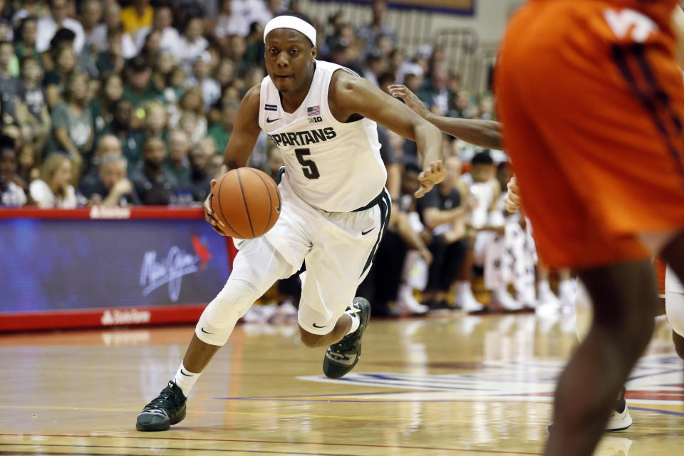 Michigan State guard Cassius Winston (5) dribbles through the Virginia Tech defense during the first half of an NCAA college basketball game Monday, Nov. 25, 2019, in Lahaina, Hawaii. (AP Photo/Marco Garcia)