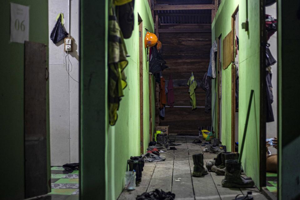 Shoes are left outside the rooms at the dormitory for construction workers at the Kalimantan Industrial Park Indonesia (KIPI) in Kampung Baru village, North Kalimantan, Indonesia on Thursday, Aug. 24, 2023. The industrial park being built in Indonesia on the tropical island of Borneo that has attracted billions of dollars in foreign and domestic investment is damaging the environment in an area where endangered species live and migrate. (AP Photo/Yusuf Wahil)