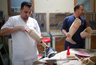 Technicians produce artificial limbs at Red Cross Physical Rehabilitation Centre in Erbil, Iraq April 2, 2017. Picture taken April 2, 2017. REUTERS/Suhaib Salem