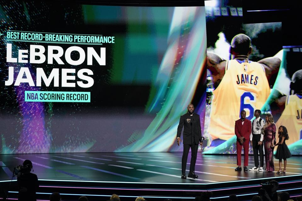 LeBron James of the Los Angeles Lakers accepts the award for best record-breaking performance from <span class="caas-xray-inline-tooltip"><span class="caas-xray-inline caas-xray-entity caas-xray-pill rapid-nonanchor-lt" data-entity-id="Bronny_James" data-ylk="cid:Bronny_James;pos:3;elmt:wiki;sec:pill-inline-entity;elm:pill-inline-text;itc:1;cat:Athlete;" tabindex="0" aria-haspopup="dialog"><a href="https://search.yahoo.com/search?p=Bronny%20James" data-i13n="cid:Bronny_James;pos:3;elmt:wiki;sec:pill-inline-entity;elm:pill-inline-text;itc:1;cat:Athlete;" tabindex="-1" data-ylk="slk:Bronny James;cid:Bronny_James;pos:3;elmt:wiki;sec:pill-inline-entity;elm:pill-inline-text;itc:1;cat:Athlete;" class="link ">Bronny James</a></span></span>, Bryce James, Savannah James and Zhuri James at the ESPY awards on Wednesday, July 12, 2023, at the Dolby Theatre in Los Angeles. | Mark Terrill, Associated Press