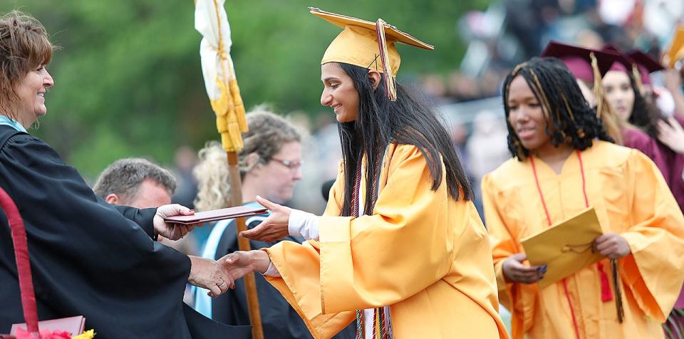 Weymouth High Valedictorian Sophia Giannandrea, center, receives her diploma from Tracey Nardone of the Weymouth School Committee during Weymouth High's graduation on Saturday, June 3, 2023.